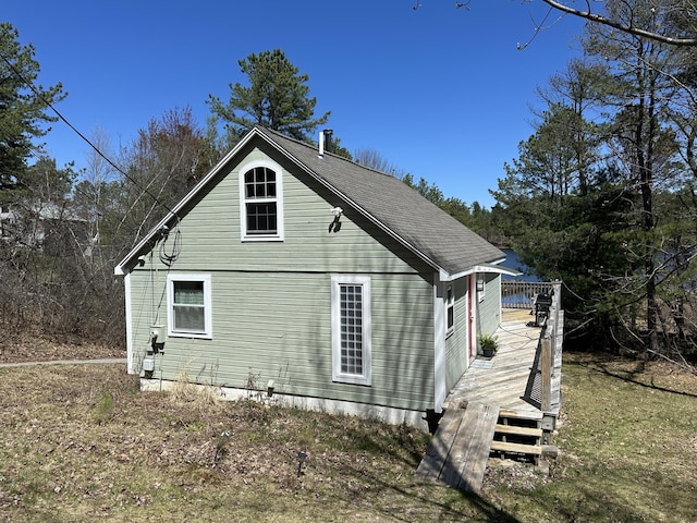view of property exterior with a wooden deck