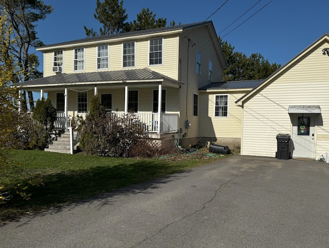 1002 River Rd, Orrington, ME 04474 - colonial-style house with a porch and metal roof