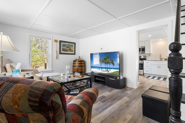 living room featuring baseboards and light wood finished floors