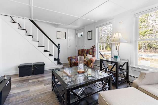 living room with baseboards, stairs, and wood finished floors