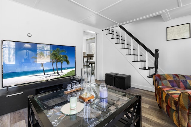 living area with wood finished floors and stairway