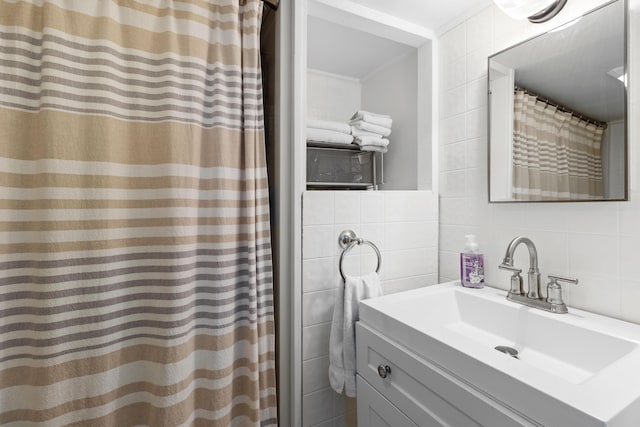full bathroom featuring tile walls and vanity