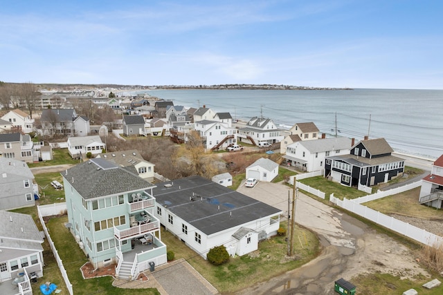 drone / aerial view with a water view and a residential view