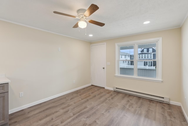 spare room featuring baseboards, ceiling fan, recessed lighting, a baseboard radiator, and light wood finished floors