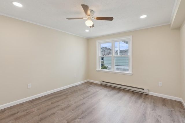 unfurnished room featuring crown molding, baseboard heating, recessed lighting, baseboards, and wood finished floors