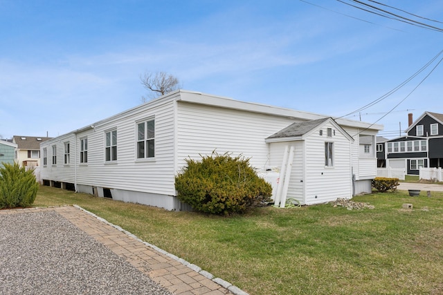 view of home's exterior with a yard
