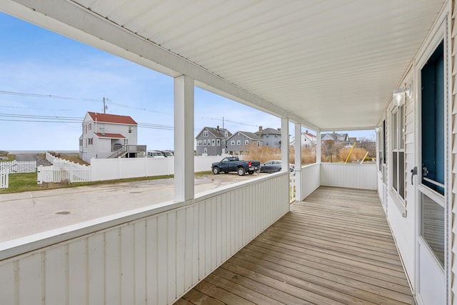 wooden deck featuring a residential view and fence