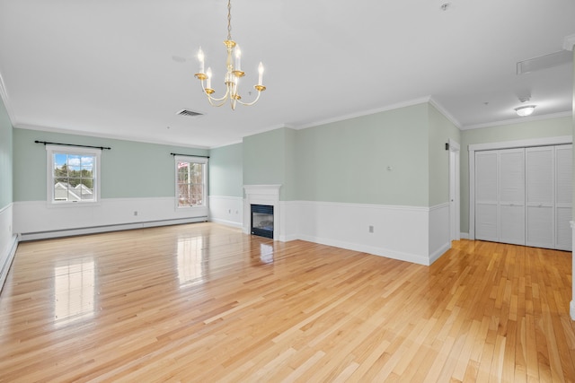 unfurnished living room featuring wood finished floors, a baseboard heating unit, visible vents, crown molding, and an inviting chandelier