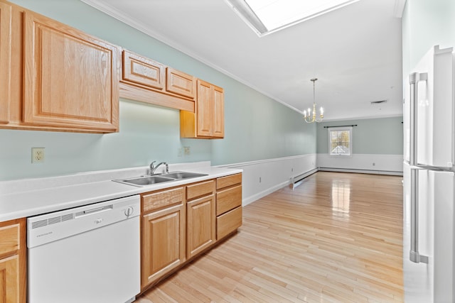 kitchen with light wood-style flooring, a sink, a notable chandelier, white appliances, and ornamental molding