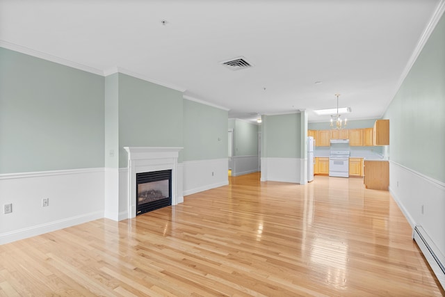 unfurnished living room with crown molding, visible vents, a baseboard heating unit, a glass covered fireplace, and light wood-style floors