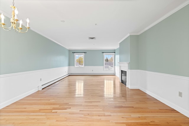 unfurnished living room featuring light wood-style floors, visible vents, a baseboard heating unit, and a glass covered fireplace