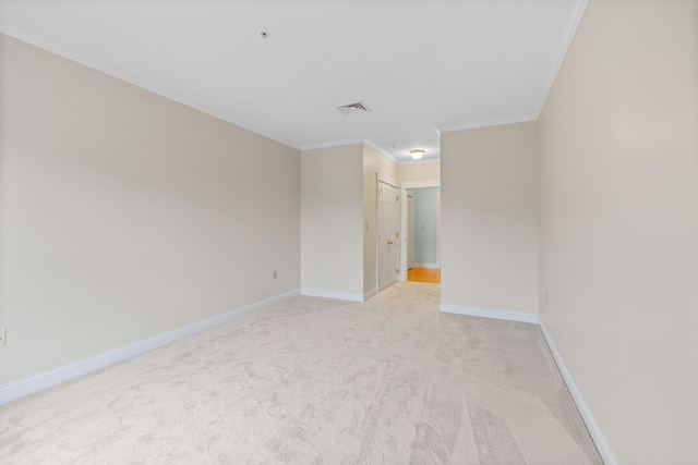 unfurnished room featuring baseboards, light carpet, ornamental molding, and visible vents
