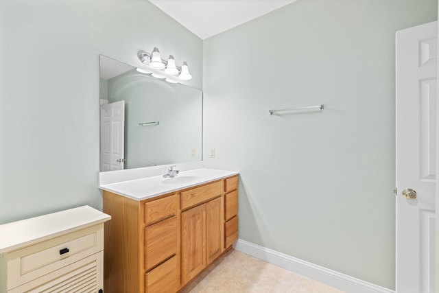 bathroom with vanity, baseboards, and tile patterned floors