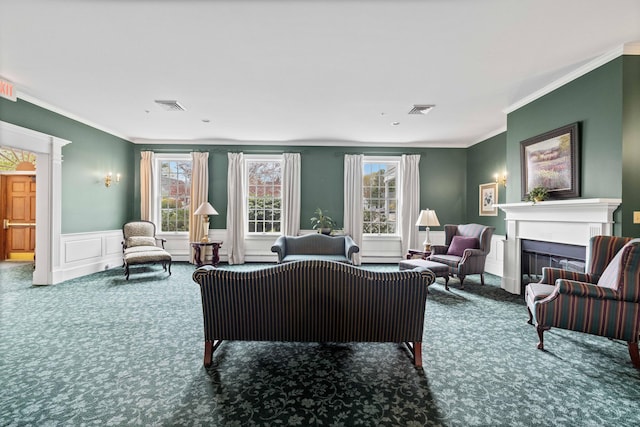 carpeted living area with a wealth of natural light, a decorative wall, a fireplace, and visible vents