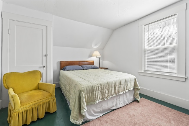 bedroom featuring carpet flooring, baseboards, and lofted ceiling