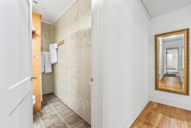 bathroom with crown molding and toilet