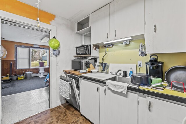 kitchen featuring white cabinetry, dark countertops, dishwashing machine, and open shelves