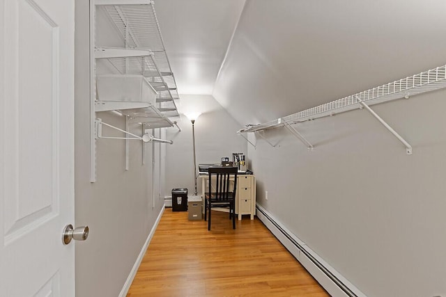 spacious closet featuring baseboard heating and light wood-type flooring