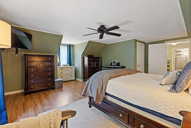 bedroom featuring baseboards, ceiling fan, and wood finished floors