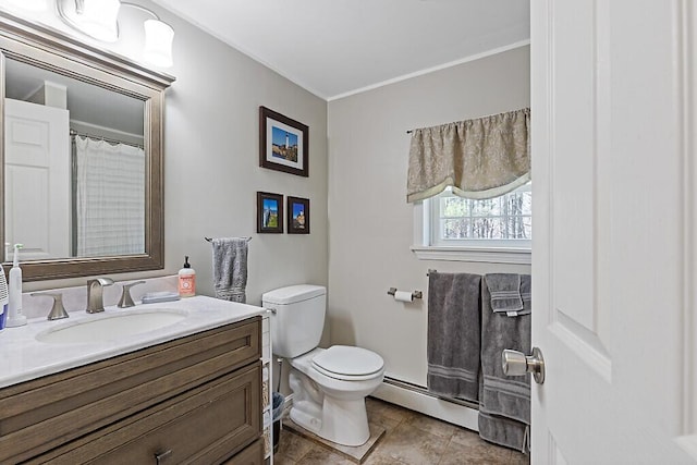bathroom with vanity, toilet, crown molding, and a baseboard radiator