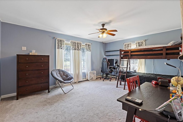 carpeted bedroom featuring baseboards and a ceiling fan