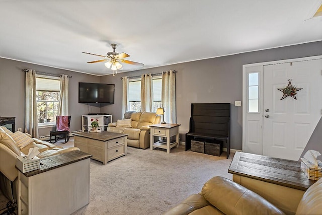 living room featuring baseboards, ceiling fan, and light carpet