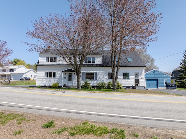 view of front facade featuring an outbuilding and a garage