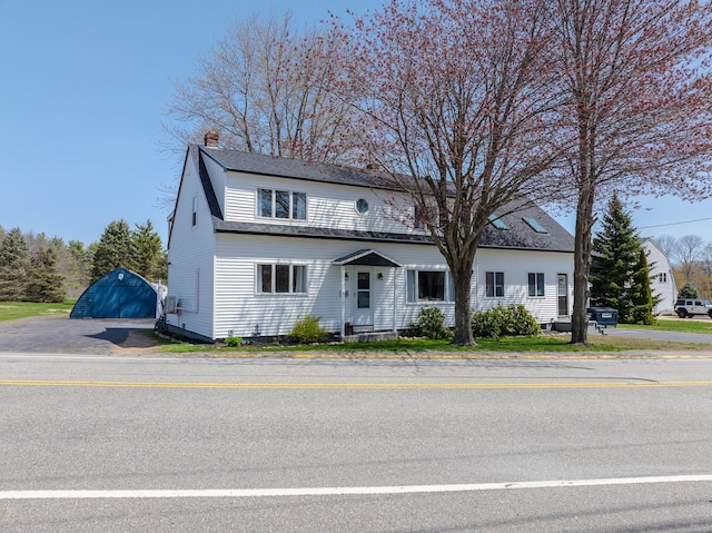 view of front of house with an outbuilding and a chimney
