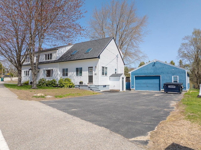 view of side of property with an outdoor structure, a garage, a storage shed, and a shingled roof