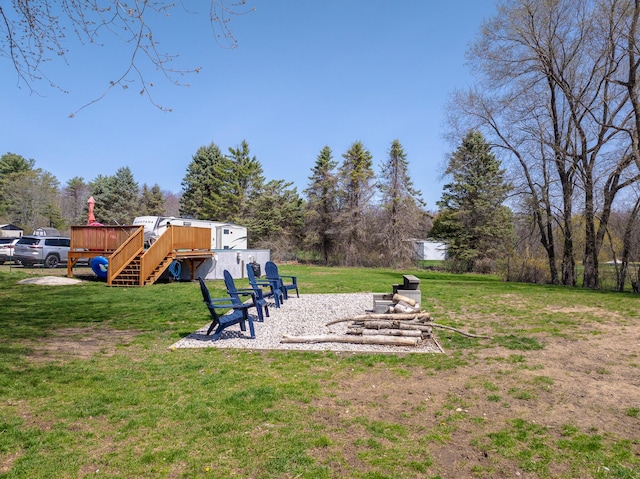 view of yard with stairs and a deck