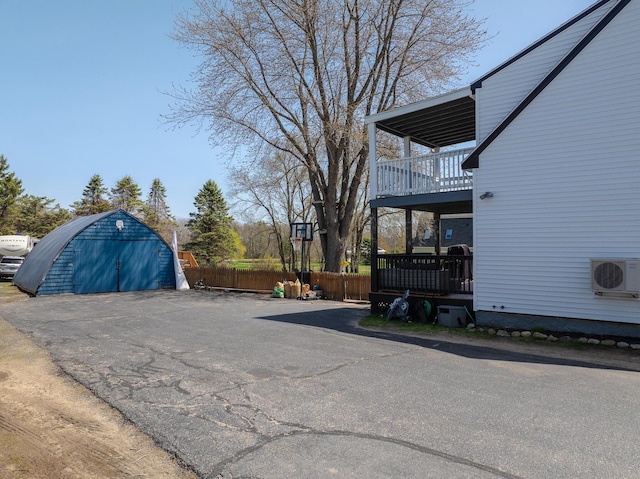 exterior space with ac unit and fence