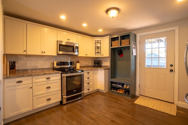 kitchen with white cabinetry, appliances with stainless steel finishes, and tasteful backsplash