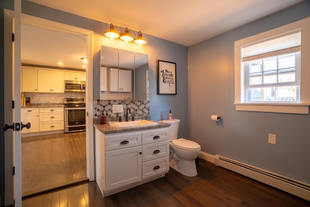bathroom featuring wood-type flooring, a baseboard radiator, backsplash, and toilet