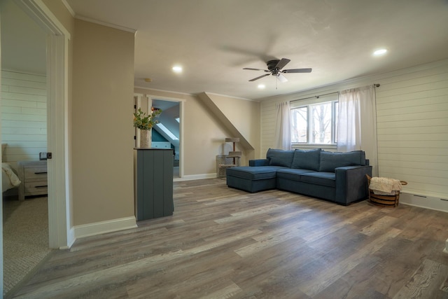 living area with crown molding, a ceiling fan, baseboards, recessed lighting, and wood finished floors