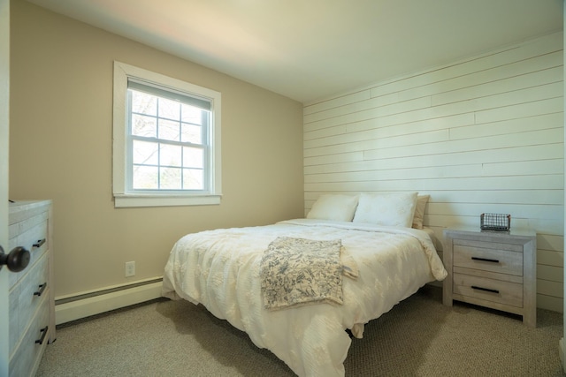 carpeted bedroom with wood walls and baseboard heating