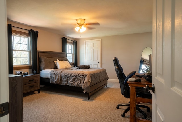 bedroom with light colored carpet and a ceiling fan