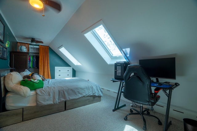 bedroom with carpet flooring, ceiling fan, and vaulted ceiling with skylight