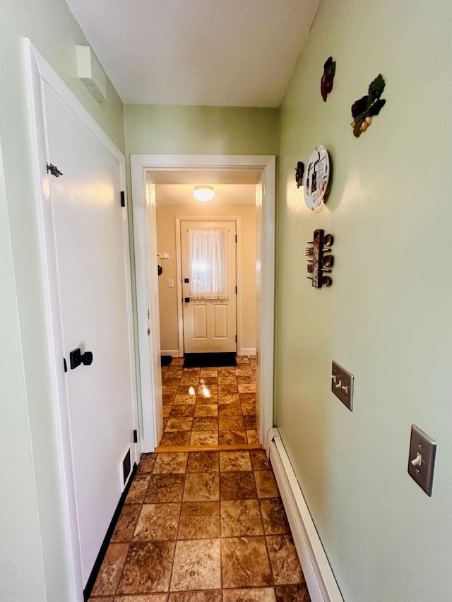 20 Patrick St, Skowhegan, ME 04976 - hall featuring dark stone finish flooring, a baseboard heating unit, and baseboards