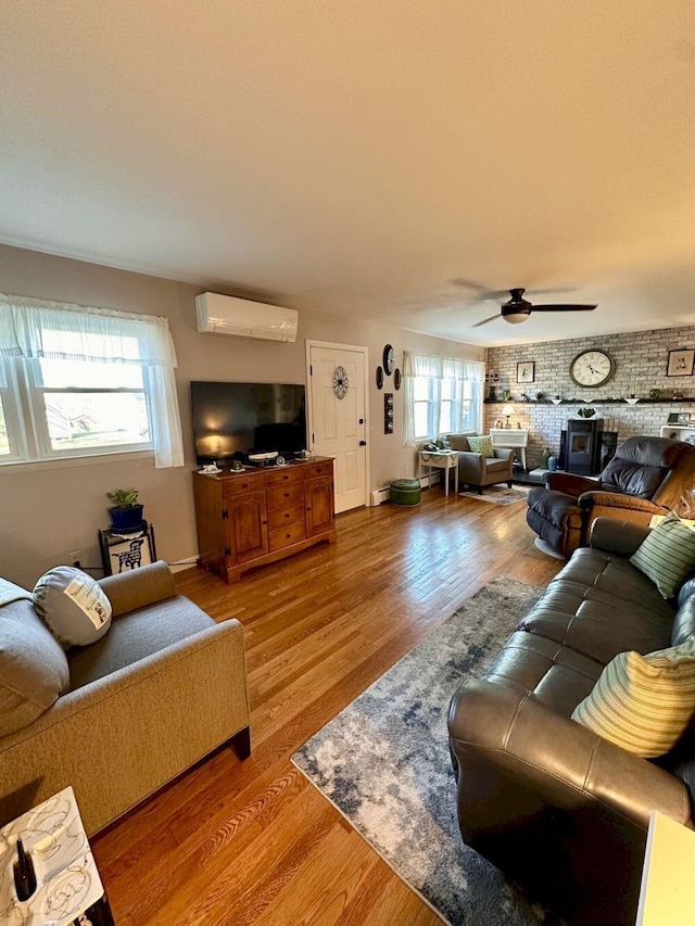 20 Patrick St, Skowhegan, ME 04976 - living room with an AC wall unit, wood finished floors, ceiling fan, and baseboards