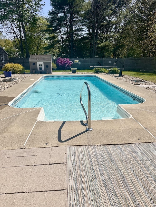 20 Patrick St, Skowhegan, ME 04976 - view of swimming pool with fence, view of scattered trees, and an outdoor structure
