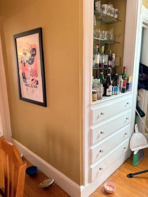 interior space featuring baseboards and wood finished floors