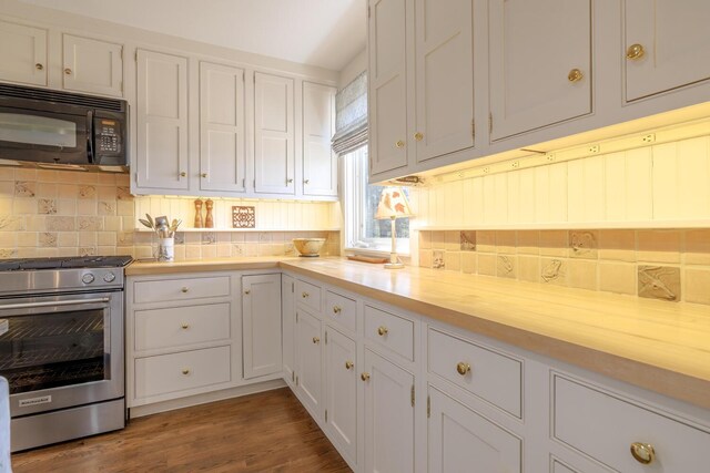 8 Spring Ln, Mount Desert, ME 04660 - kitchen featuring high end range, black microwave, backsplash, white cabinetry, and wood finished floors