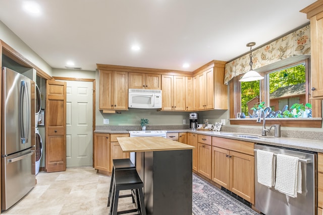51 Beaver Dam Rd, South Berwick, ME 03908 - kitchen with appliances with stainless steel finishes, stacked washing machine and dryer, a sink, wood counters, and hanging light fixtures