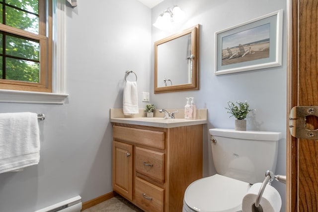 51 Beaver Dam Rd, South Berwick, ME 03908 - half bath with a baseboard radiator, vanity, toilet, tile patterned floors, and baseboards