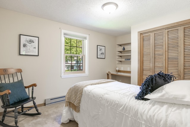 51 Beaver Dam Rd, South Berwick, ME 03908 - bedroom with carpet floors, baseboard heating, a closet, a textured ceiling, and baseboards