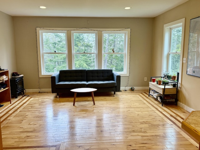 8 Berry Ln, Vinalhaven, ME 04863 - sitting room with plenty of natural light, a wood stove, light wood-style floors, and recessed lighting