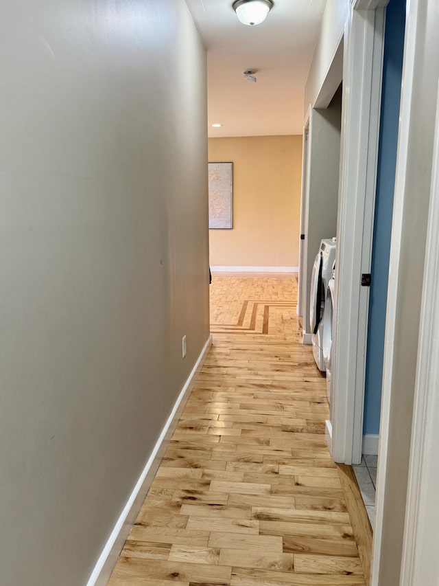 8 Berry Ln, Vinalhaven, ME 04863 - hallway with light wood-style flooring, baseboards, and washing machine and dryer