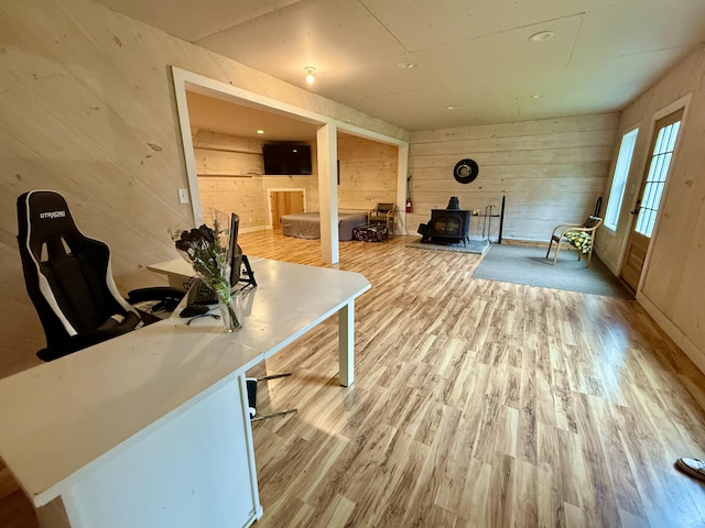 8 Berry Ln, Vinalhaven, ME 04863 - office space with a wood stove, wood walls, and light wood-type flooring