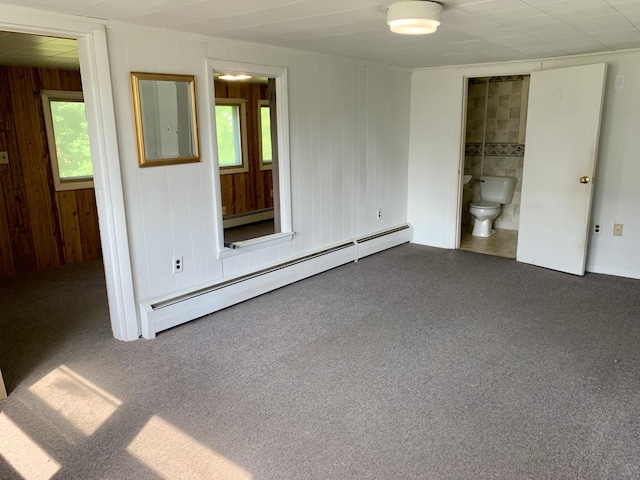 interior space with plenty of natural light, carpet flooring, and baseboard heating