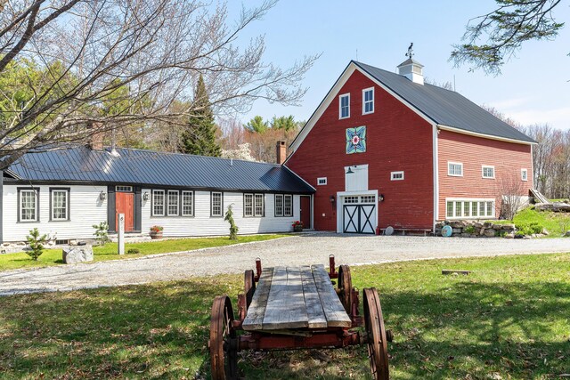 875 N Parish Rd, Turner, ME 04282 - back of house with a barn, a yard, driveway, and metal roof